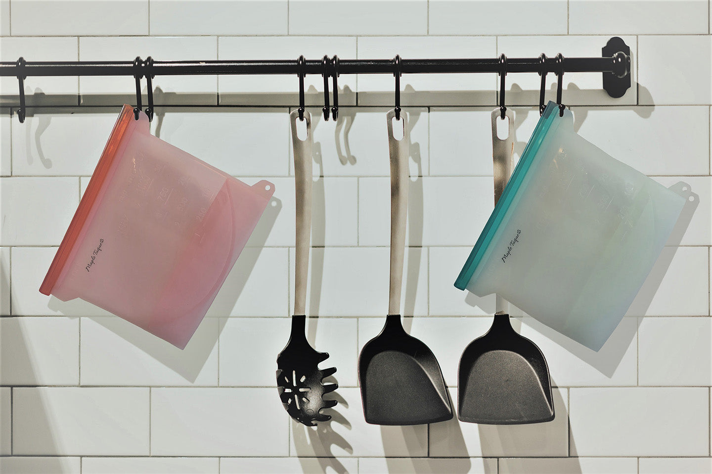Reusable Silicone Food Bags Capacity: 1L Silicone bags hanging on hooks with kitchen utensils.